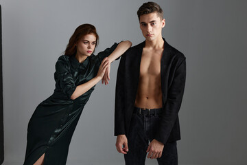 A beautiful woman is leaning on the shoulder of a sexy man in a suit