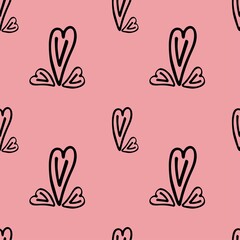 Seamless fabric with hearts of different sizes on a pink background.