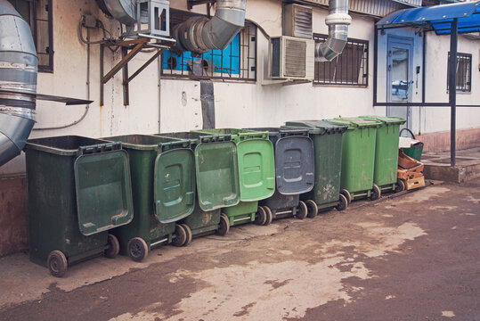 A Row Of Green Dumpsters