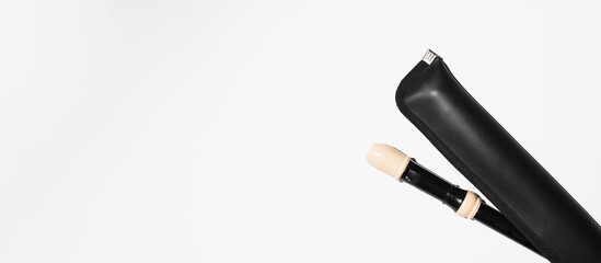Musical flute in a black leather case, top view. Banner, copy space