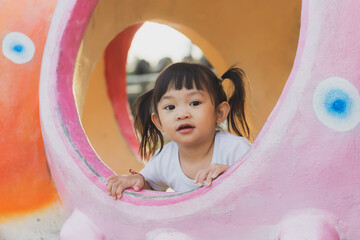 Portrait image of 2-3 years old of toddler baby girl. Happy Asian child playing with the toy at the park playground. Learning and kid concept.
