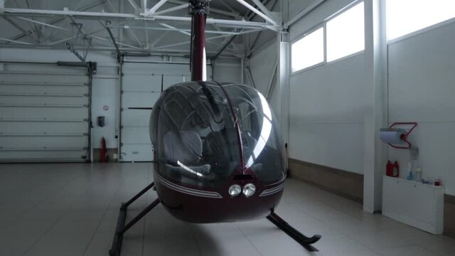 helicopter Robinson R44 parked in the hangar