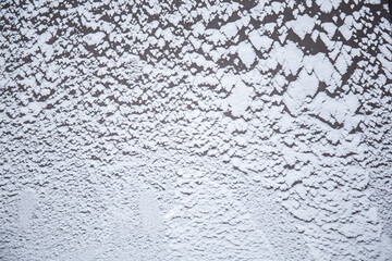 Snow texture on a dark surface. Winter background
