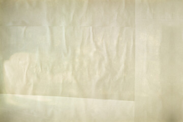 亜麻色のしわくちゃな紙の背景。貼り合わせた四角い紙。古めかしい汚れたテクスチャ。