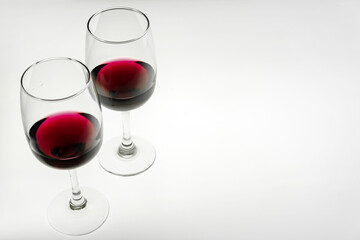 Two glasses of red wine on a light background. Copy space. Horizontal photo