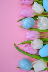 Easter holiday. White and pink tulips flowers,blue easter eggs  set on a light pink background.Easter  eggs and spring flowers in pastel colors set.Spring festive easter background.Easter symbol.