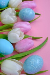 Fototapeta na wymiar Easter holiday. White and pink tulips flowers,blue easter eggs on a light pink background.Easter eggs and spring flowers in pastel colors set.Spring festive easter background.Easter symbol.