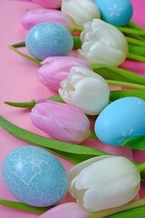 Fototapeta na wymiar Easter holiday. White and pink tulips flowers,blue easter eggs set on a pink background.Easter eggs and spring flowers in pastel colors set.Spring festive easter background.Easter symbol.