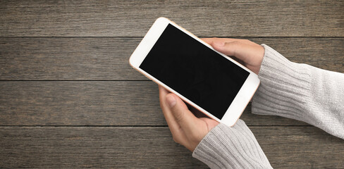 Hand holding smartphone device touching screen