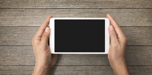 Hands holding  tablet touch computer gadget with isolated screen