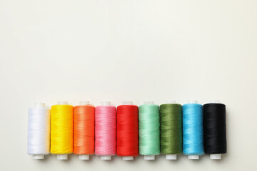 Color sewing threads on white background, space for text