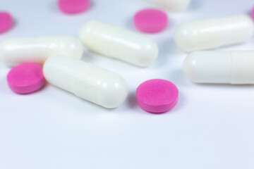 Colored pills on white background. Close up. Medical treatment concept.