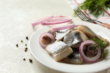 Concept of lunch with plate of fresh herring fish on white textured background