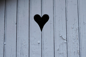 heart on gey door wooden background