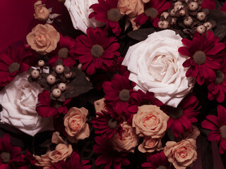 A beautiful bouquet of various flowers including roses. Floral background. Holiday postcard