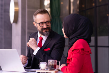 Muslim business woman wearing hijab and caucasian businessman, Marketing plan Market analysis With the future world business.