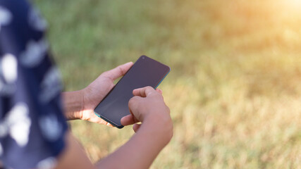 Close up of a man using mobile smart phone outdoor.