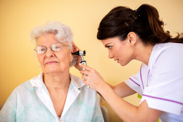 Nursing home doctor with her senior woman occupant patient, routine checkup