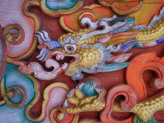 Beautiful colorful traditional bhutanese woodcarving of a dragon in Zangdkok Palri lhakang near Kurjey in Bumthang valley, Bhutan