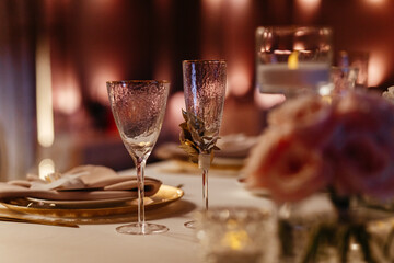Champagne and wine glasses on the blurred background. Place for your text. Table setting in the restaurant