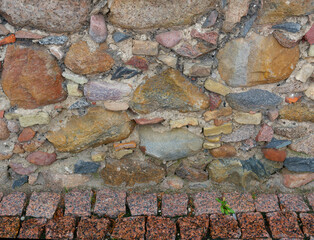 A wall of waves and stones of different sizes.