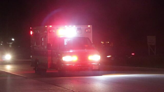 An ambulance flashing its lights at night.