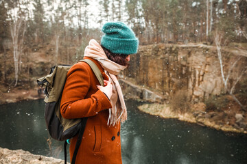 Young beautiful model posing in winter forest.