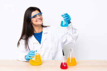 Young scientific woman in a table