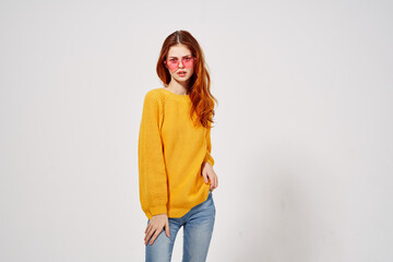 cheerful woman in a yellow sweater pink glasses emotions hand gestures