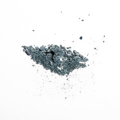 scattered turquoisematte eyeshadow on white background. Shallow depth of field.