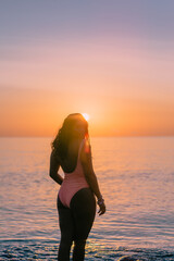 Silhouette of a girl on the beach at sunsrise