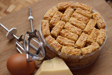 cookies on a plastic jar with egg and cheese on a wooden board