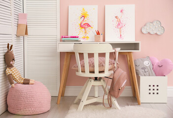 Stationery and pictures on white table in children's room. Interior design