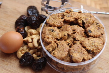 chocolate cookies with raisins and peanuts on a wooden table