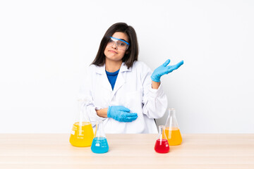 Young scientific woman in a table unhappy for not understand something