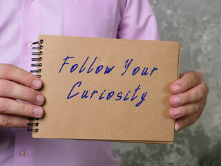 Lifestyle concept about Follow Your Curiosity with inscription on the page.
