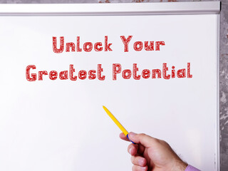 Motivational concept about Unlock Your Greatest Potential with phrase on the sheet.