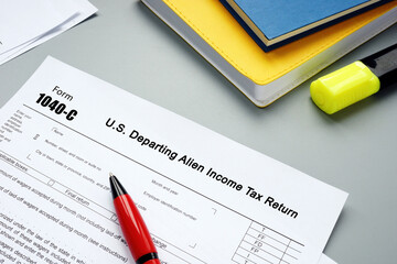 Conceptual photo about Form 1040-C U.S. Departing Alien Income Tax Return with written phrase.