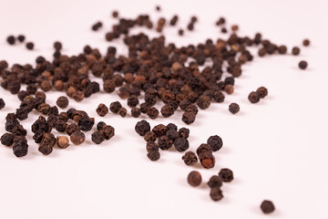 black and brown balls are scattered on a white surface