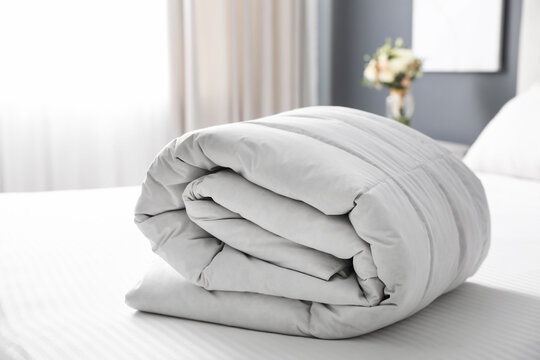 Soft folded blanket on bed at home