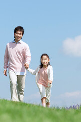 Fototapeta premium 手をつないで走る親子