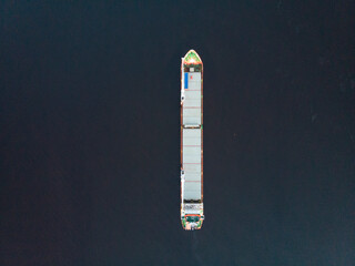 Top view of the container ship. Cargo ship on the water.
 - Powered by Adobe