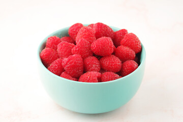 A bowl with ripe bright raspberries