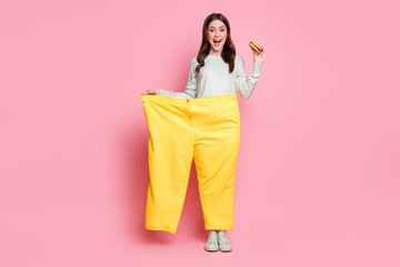 Full body portrait of astonished person big pants hand hold cheeseburger open mouth isolated on...