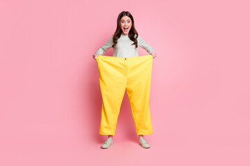 Full length portrait of funky playful person open mouth wear too big pants isolated on pink color...