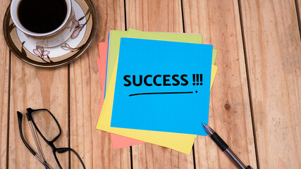 Success quotes in blue paper on top table. Business concept. Still life