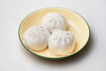 Close up a plate of steamed BBQ pork bun 