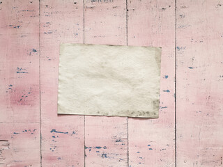 paper on pink wooden background