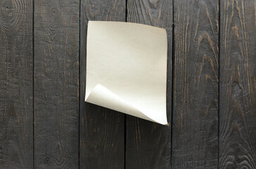 old paper on dark wooden wall