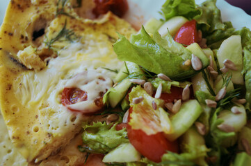 omelette and salad of fresh vegetables on a plate delicious light breakfast macro photo culinary background